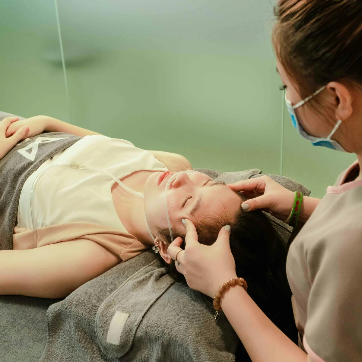 Indian head massage in progress, representing facial, head, and ear care treatments.