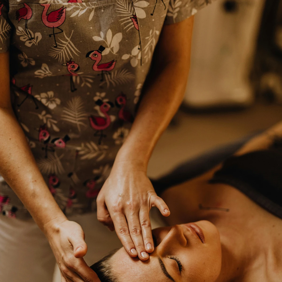 Indian head massage in progress, focused around the scalp, neck, and upper shoulders.