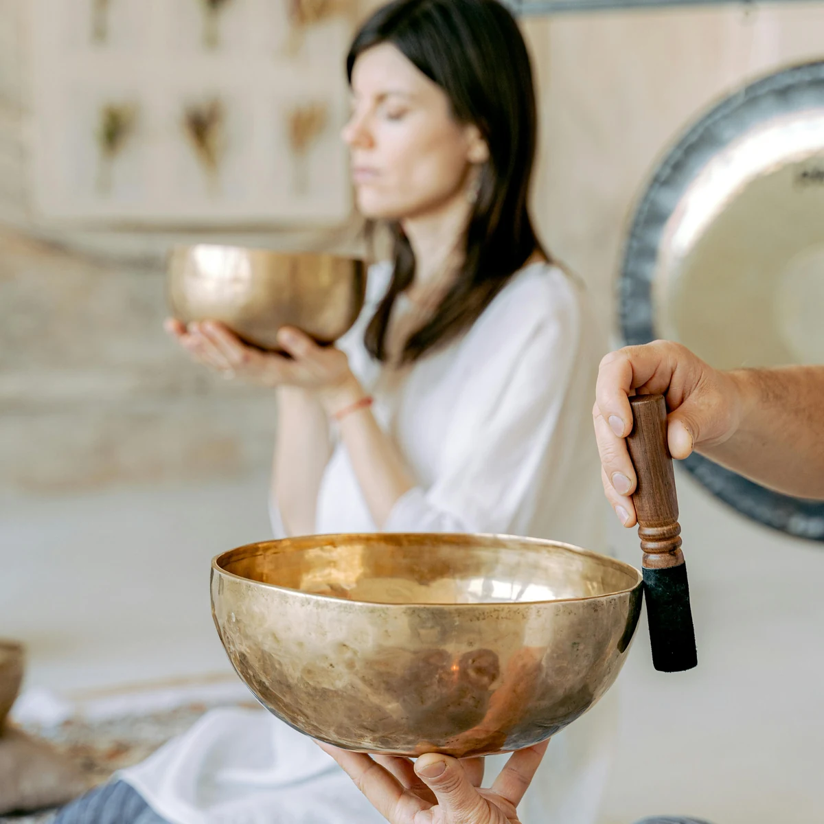 Sound-based energy treatment in progress with bowls used for a calm, slower session.